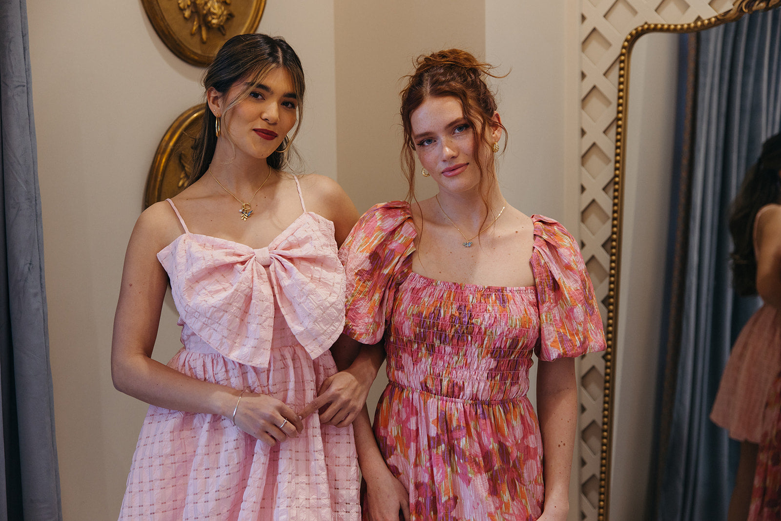 2 girls wearing pink dresses