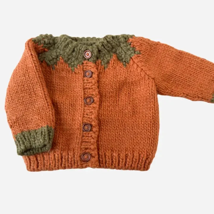 Knitted sweater with green trim on a white background