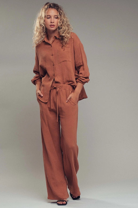Woman wearing a brown outfit against a plain background