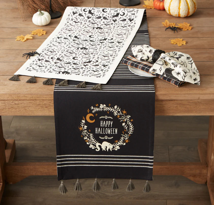 Halloween-themed table runner with decorative elements on a wooden table.