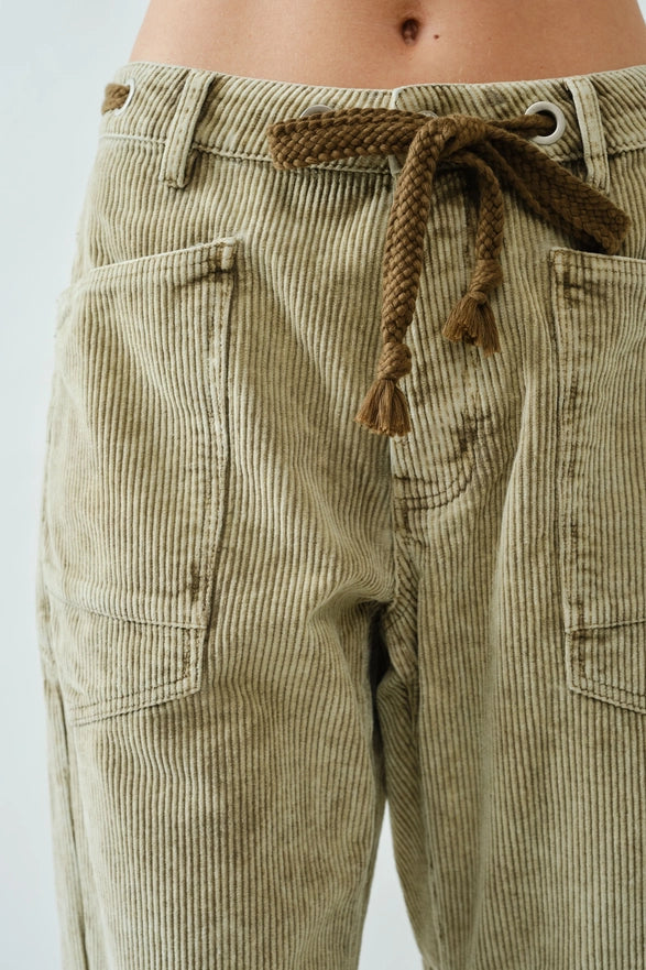 Beige corduroy pants with a drawstring on a white background