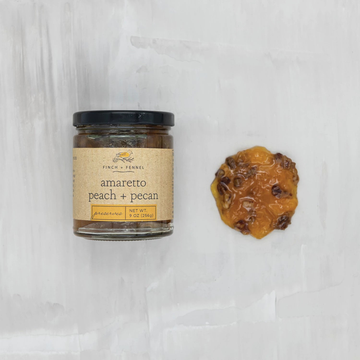 Product shoot of amaretto peach and pecan preserves container.