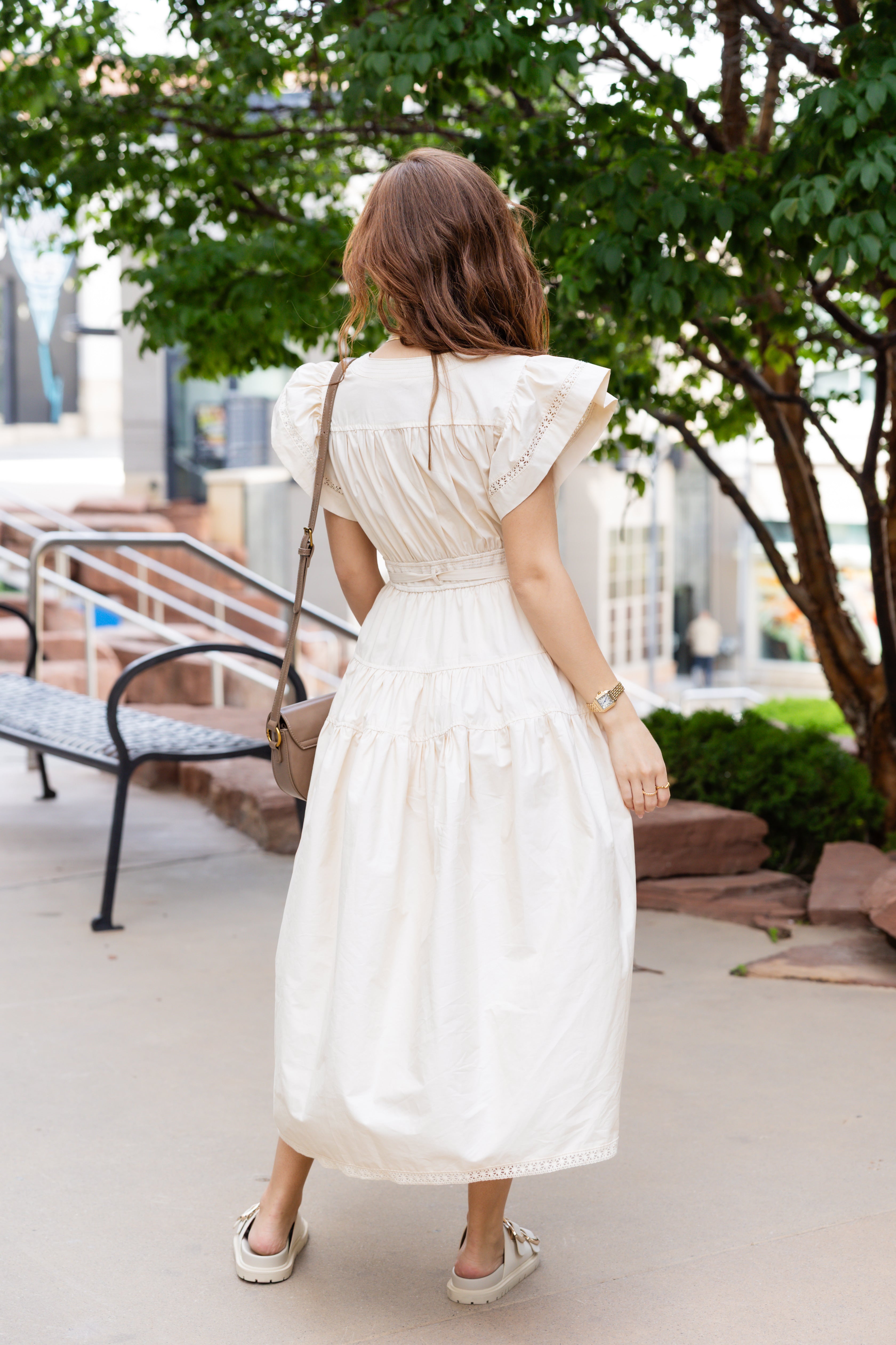Flutter sleeves, a tiered skirt, and a cinched tie waist midi dress.