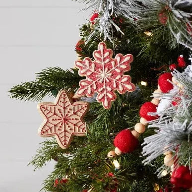 Decorative Christmas tree with snowflake ornaments and a Santa Claus figure.