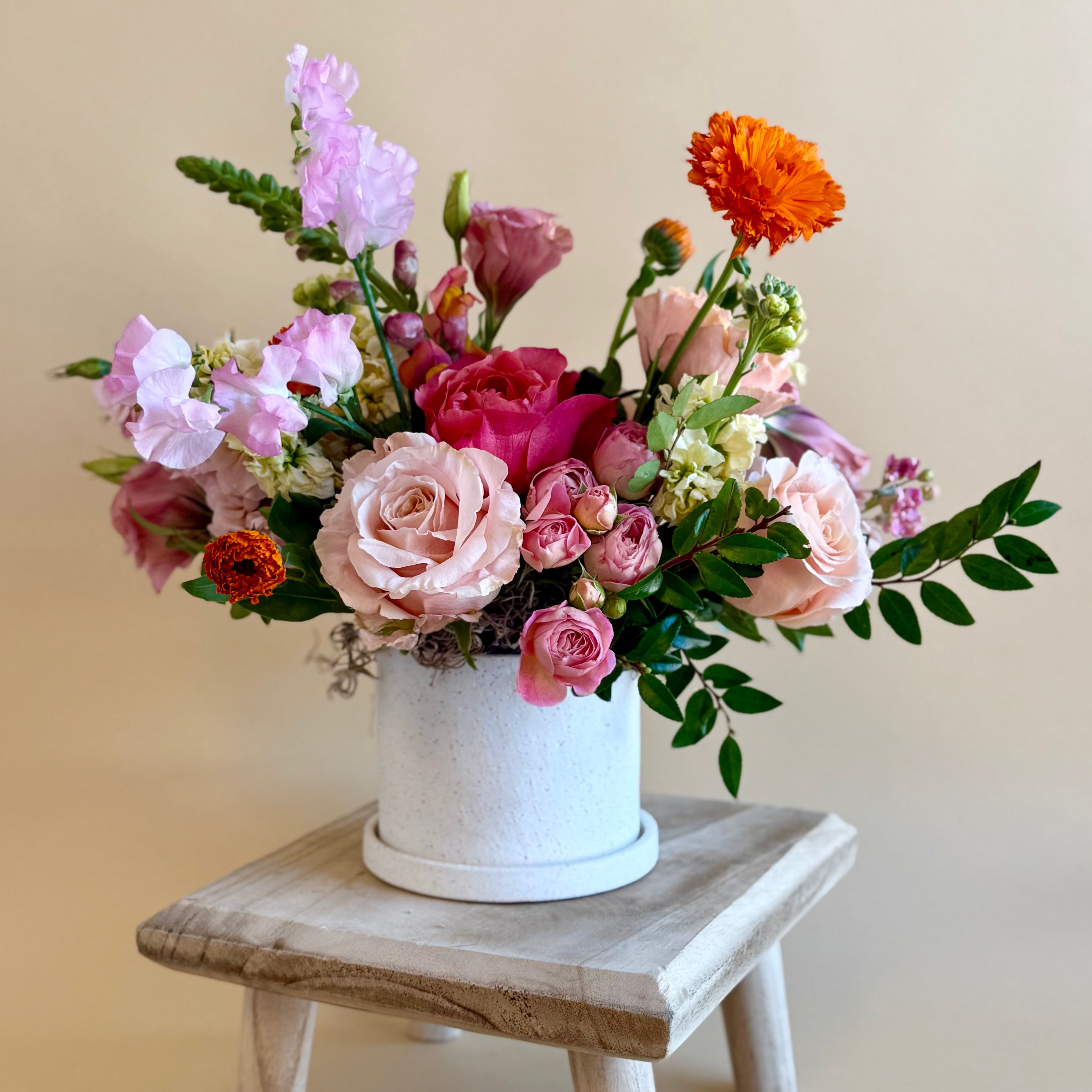 Bright pink and orange floral vase arrangement