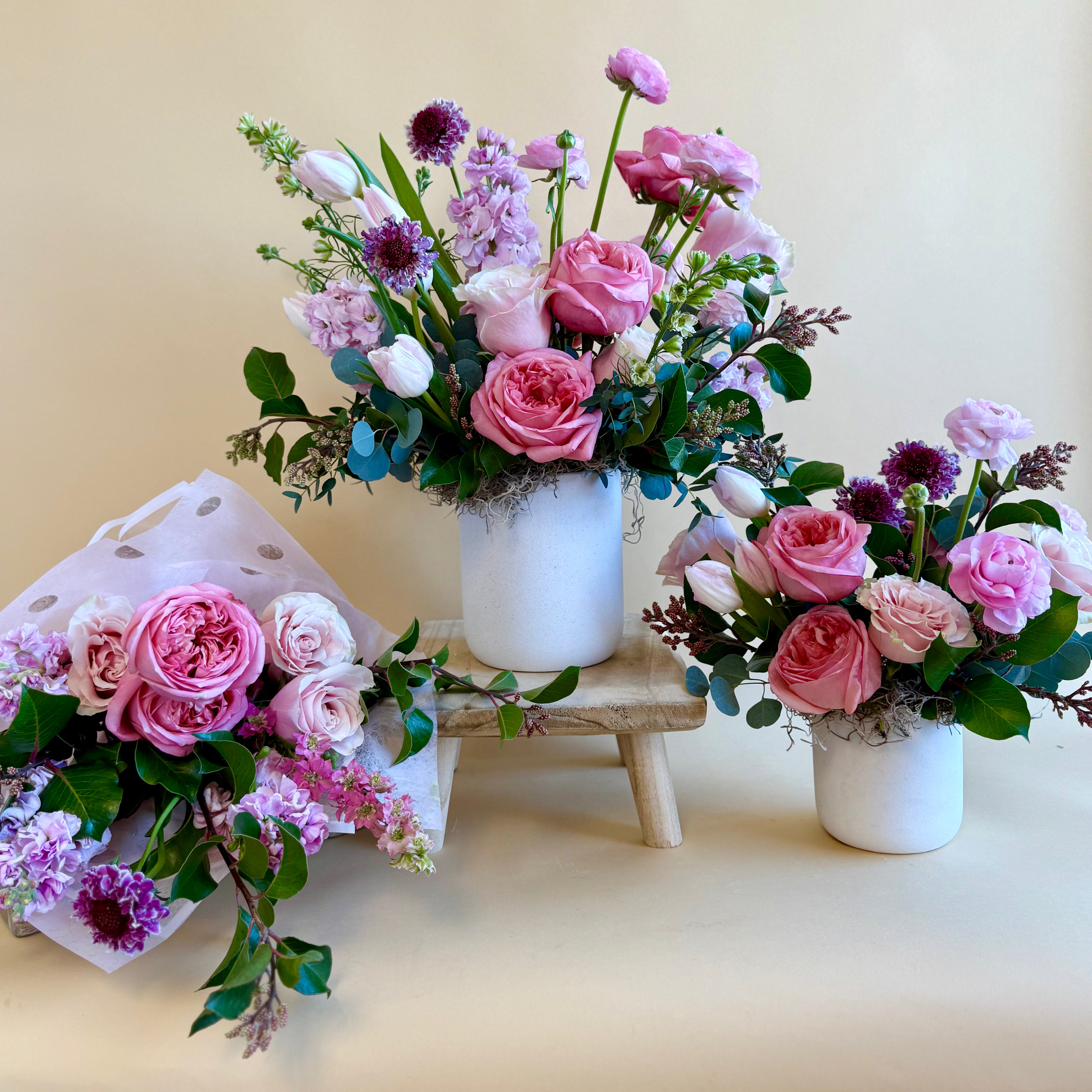 Purple and pink floral bouquet loose wrap, and vase arrangement