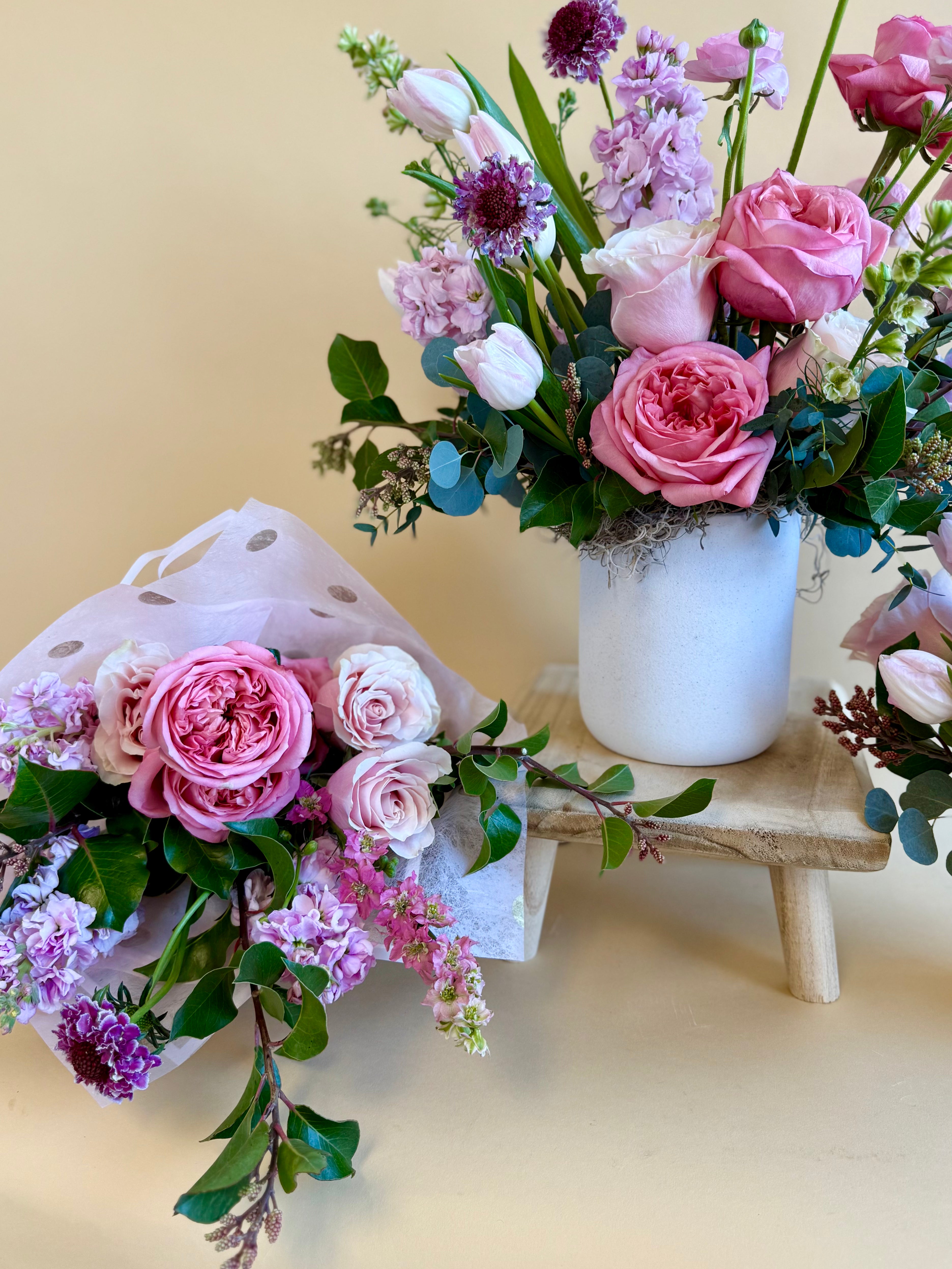Purple and pink floral bouquet loose wrap, and vase arrangement