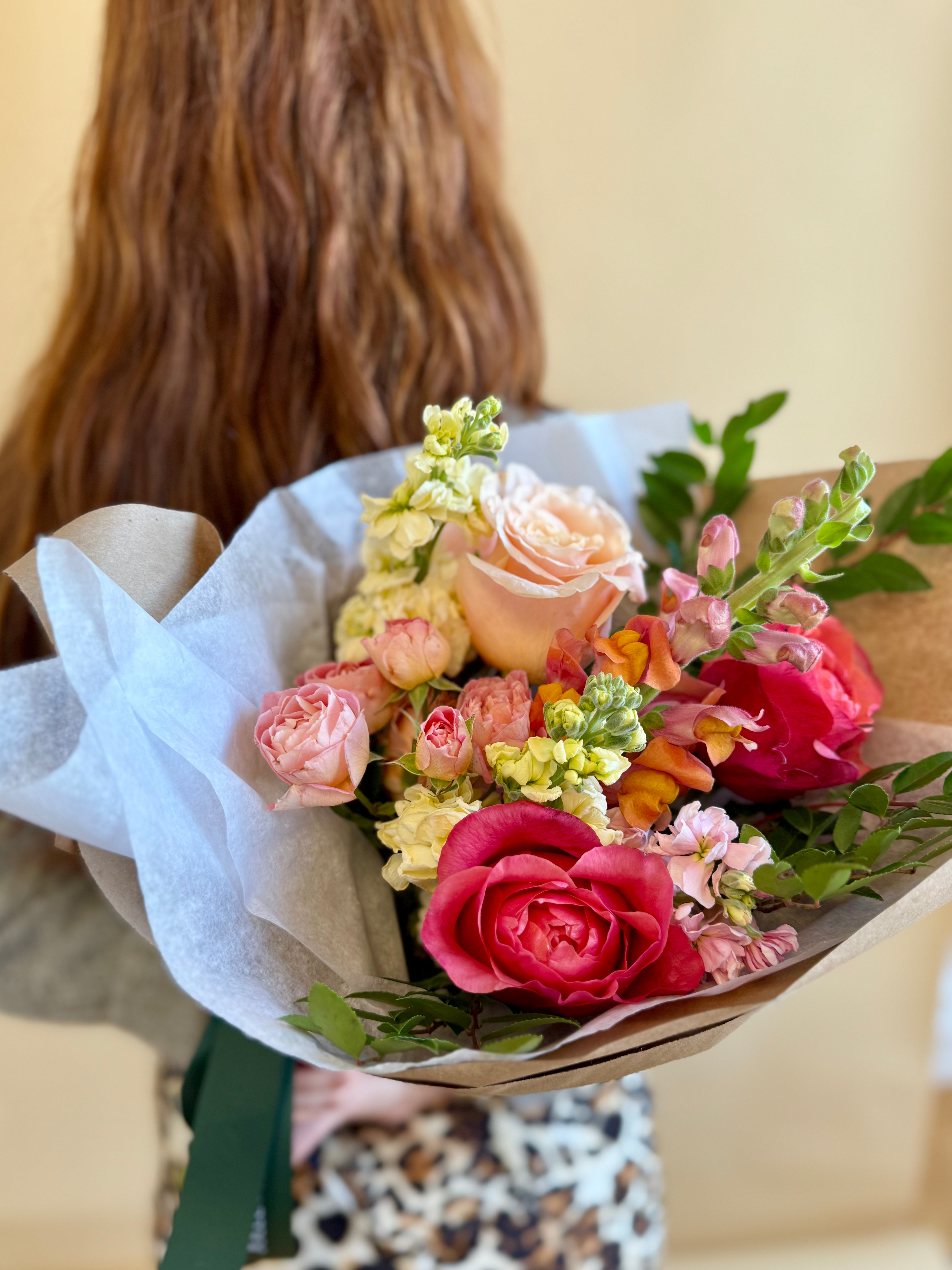 Bright pink and orange floral bouquet loose wrap arrangement