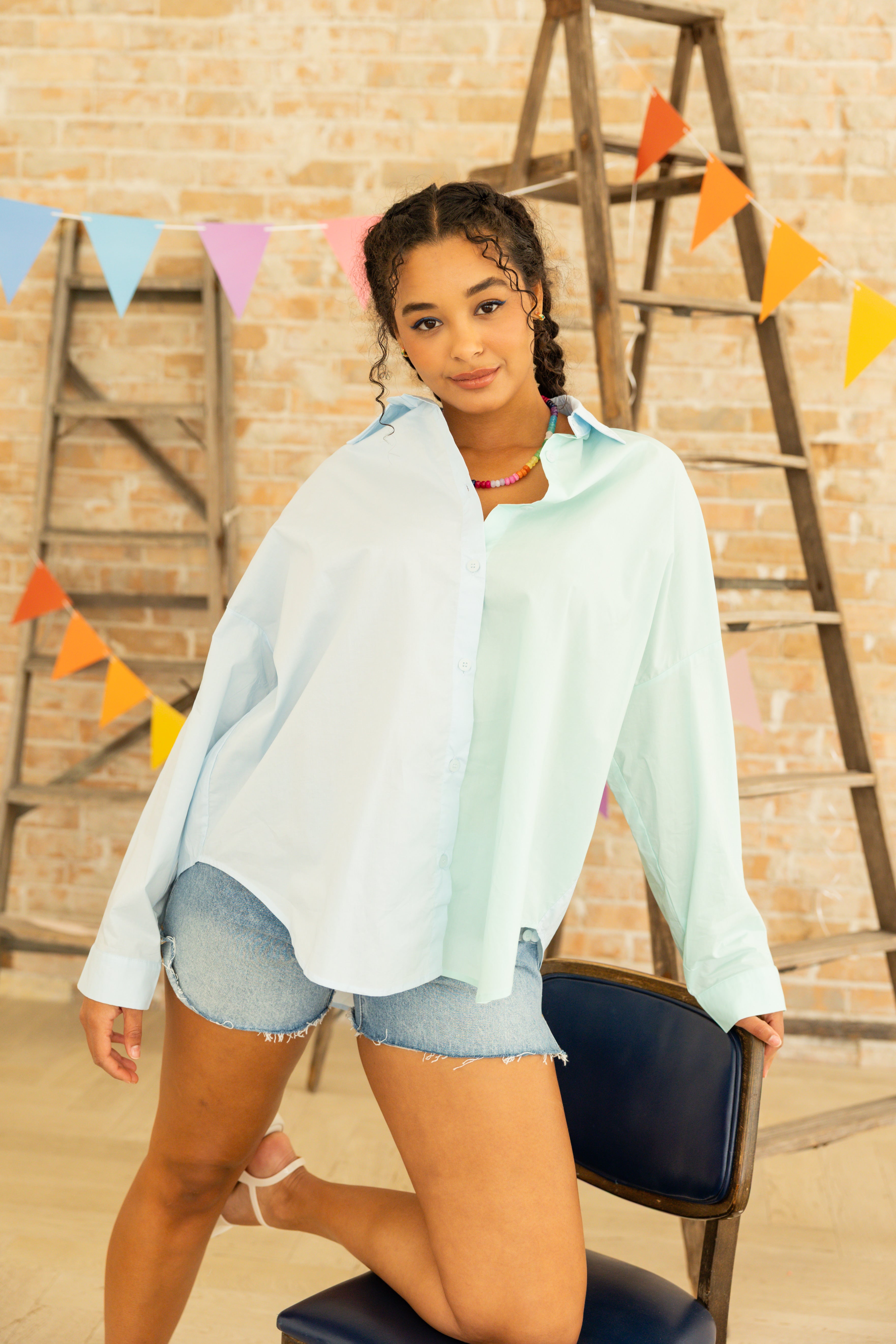 Model is wearing oversized color blocking button up dress shirt.
