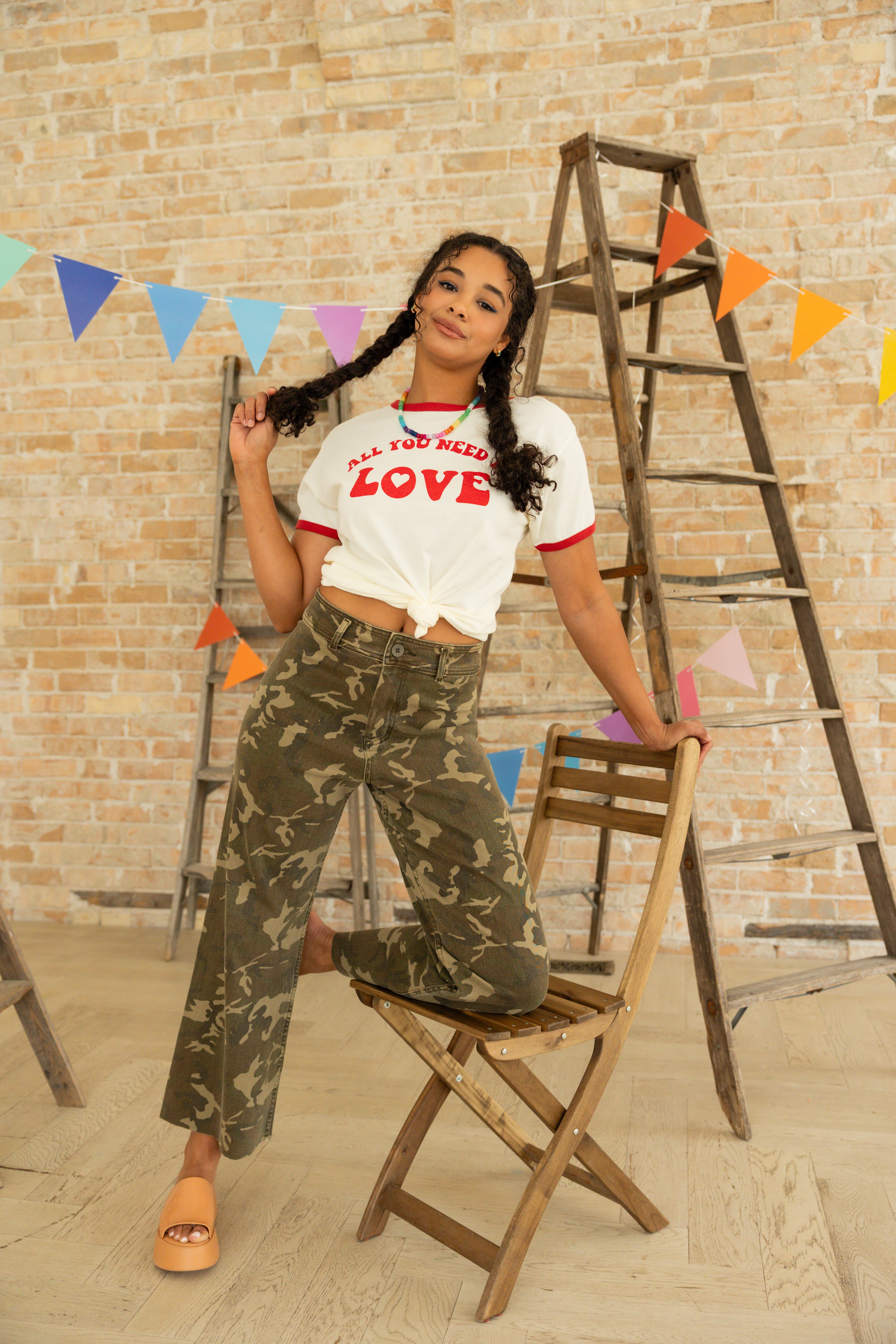 Model is wearing green camo high waist wide leg pants.