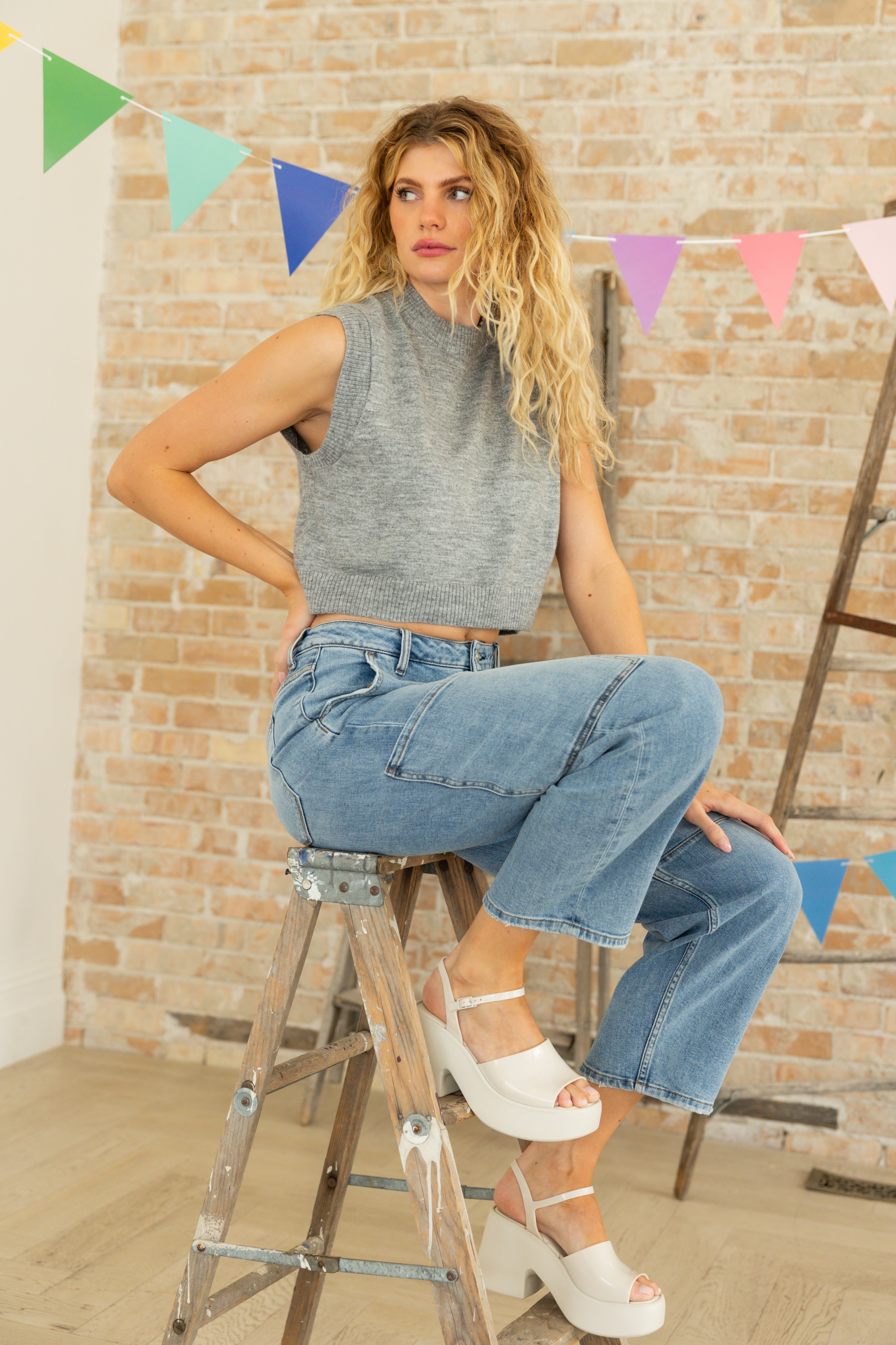 Model is wearing medium wash cargo barrel jeans.