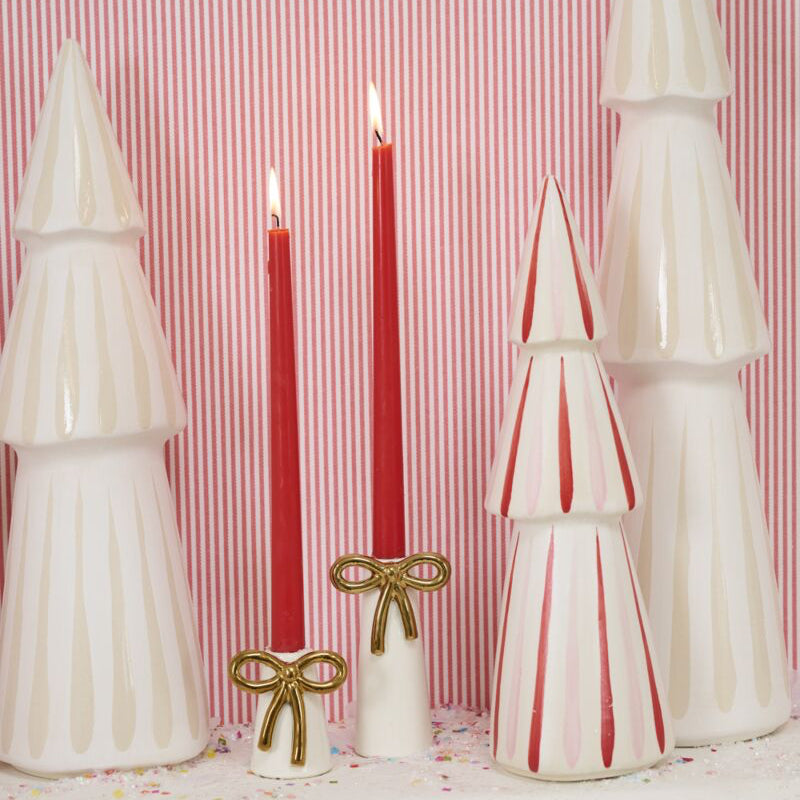 Decorative Christmas trees and candles on a striped background