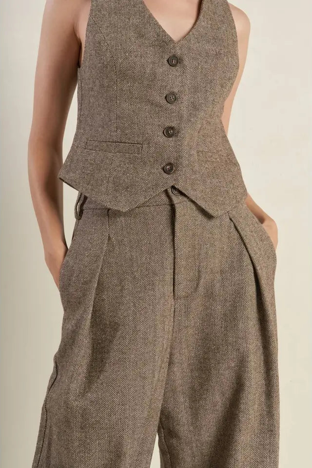 Brown herringbone suit vest and pants on a neutral background
