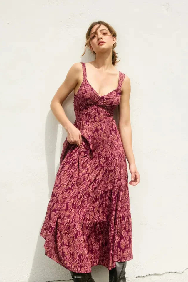 Woman wearing a red floral dress against a white background