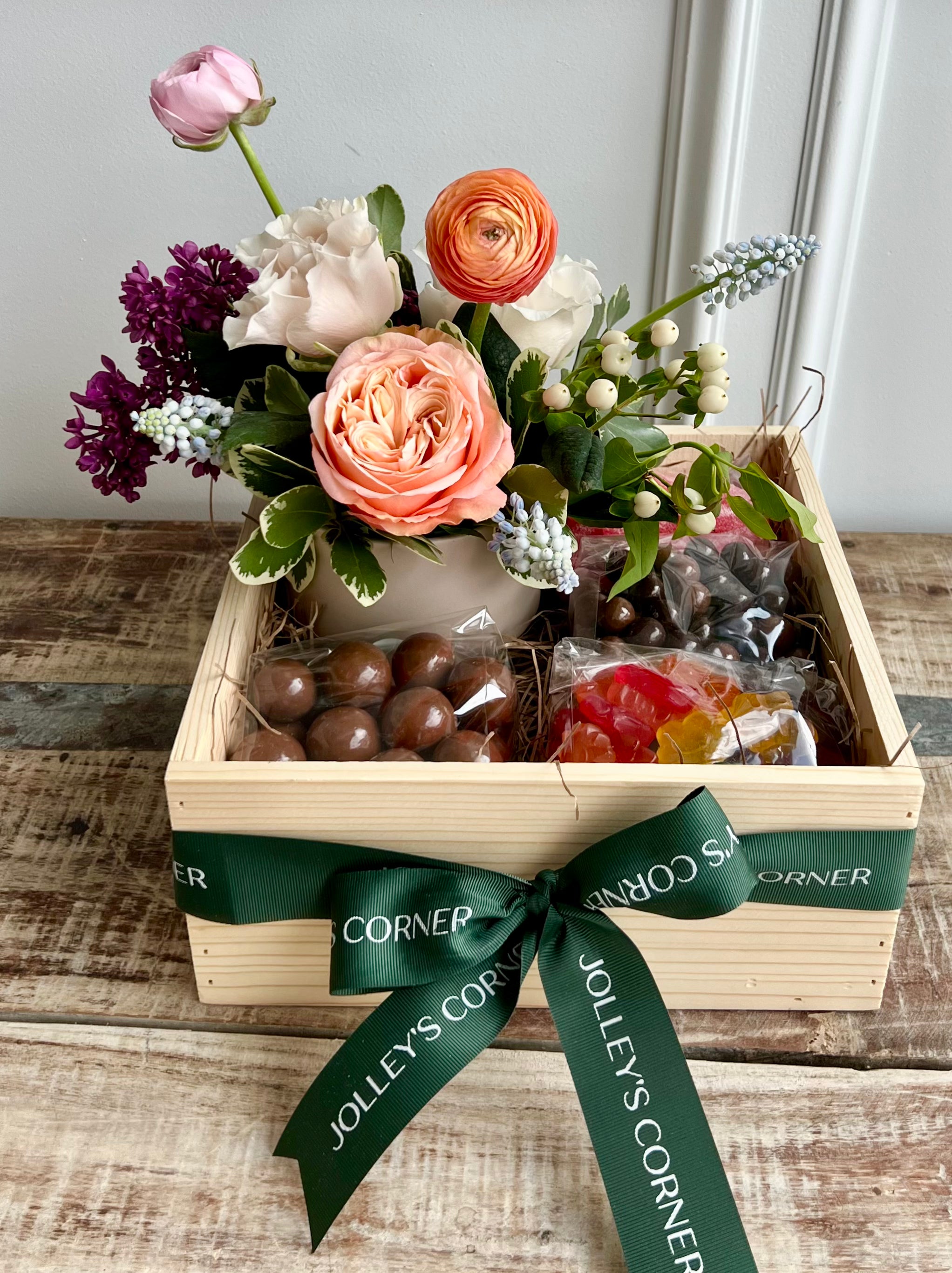 Gift baskets with floral arrangements and candy.