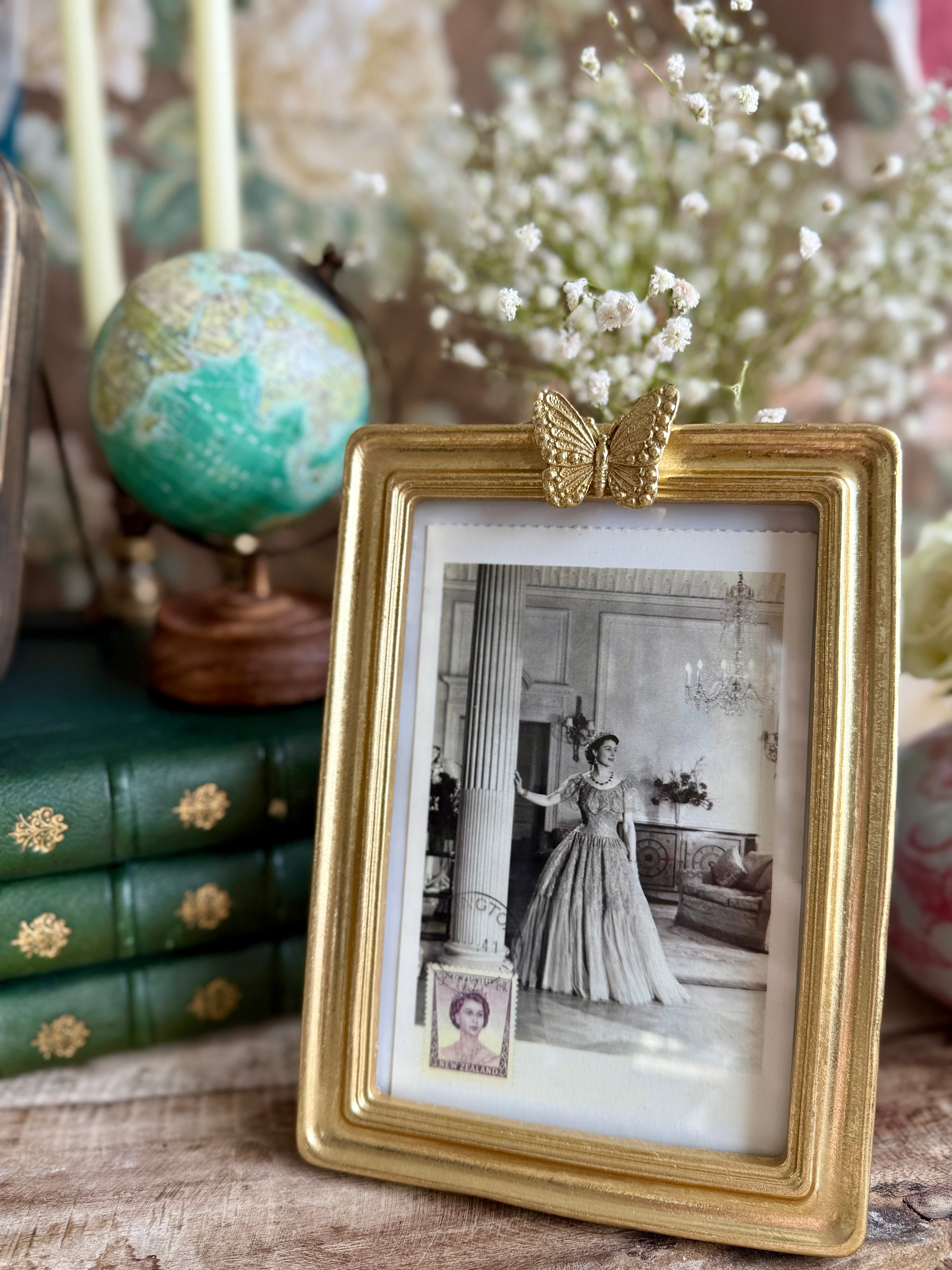 Product shoot of butterfly gold vintage photo frame.