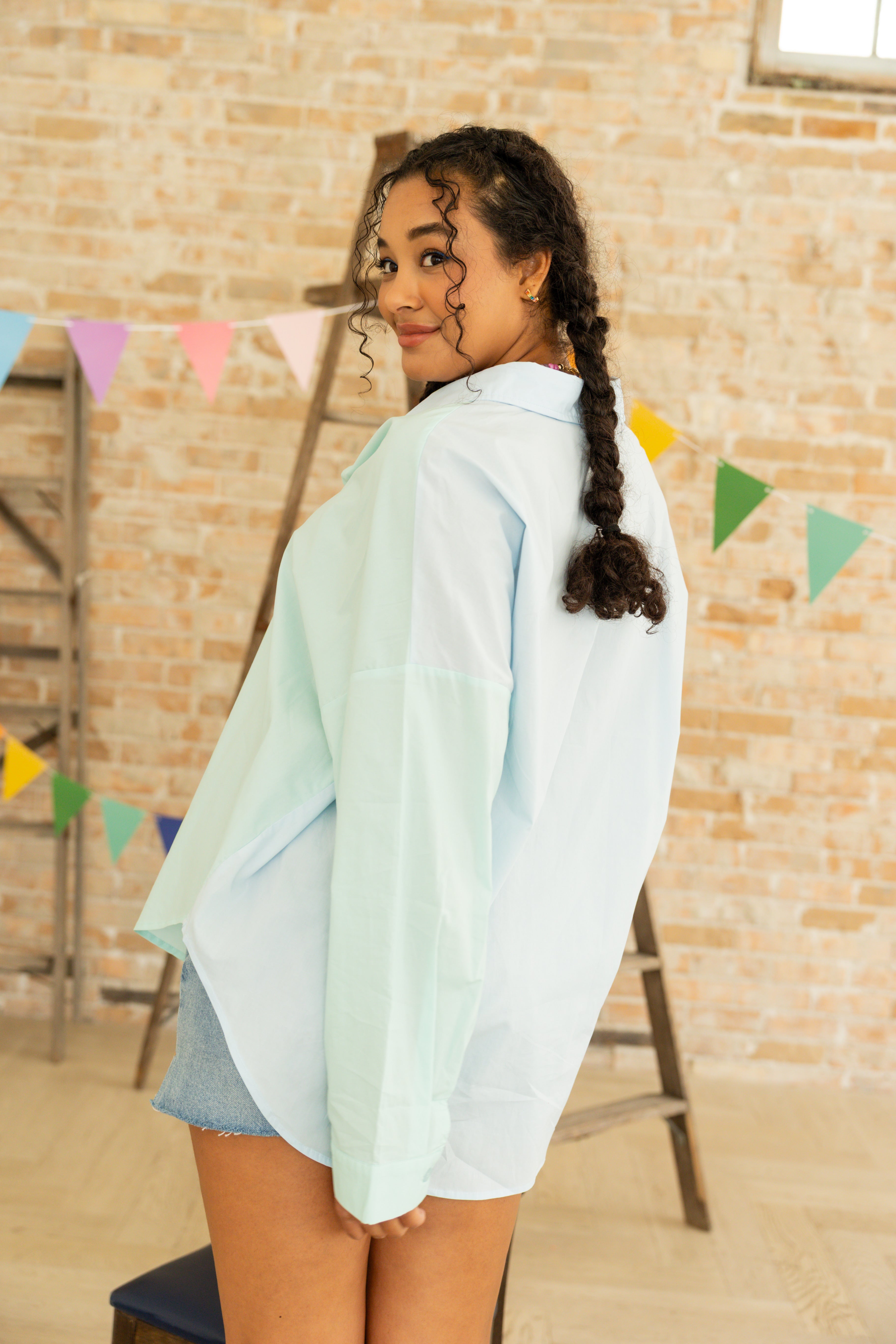 Model is wearing oversized color blocking button up dress shirt.