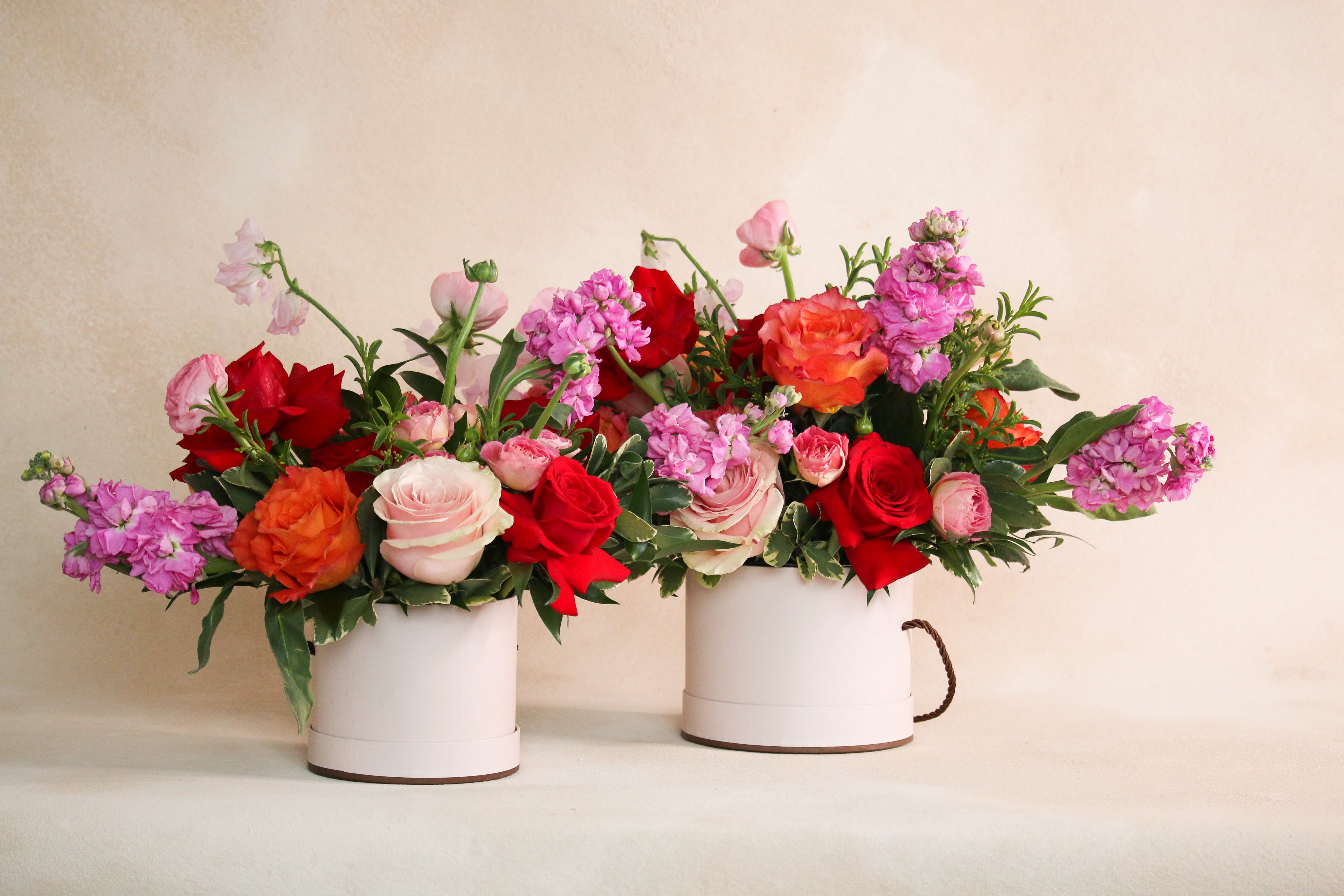 Floral vase arrangement with red pink orange roses