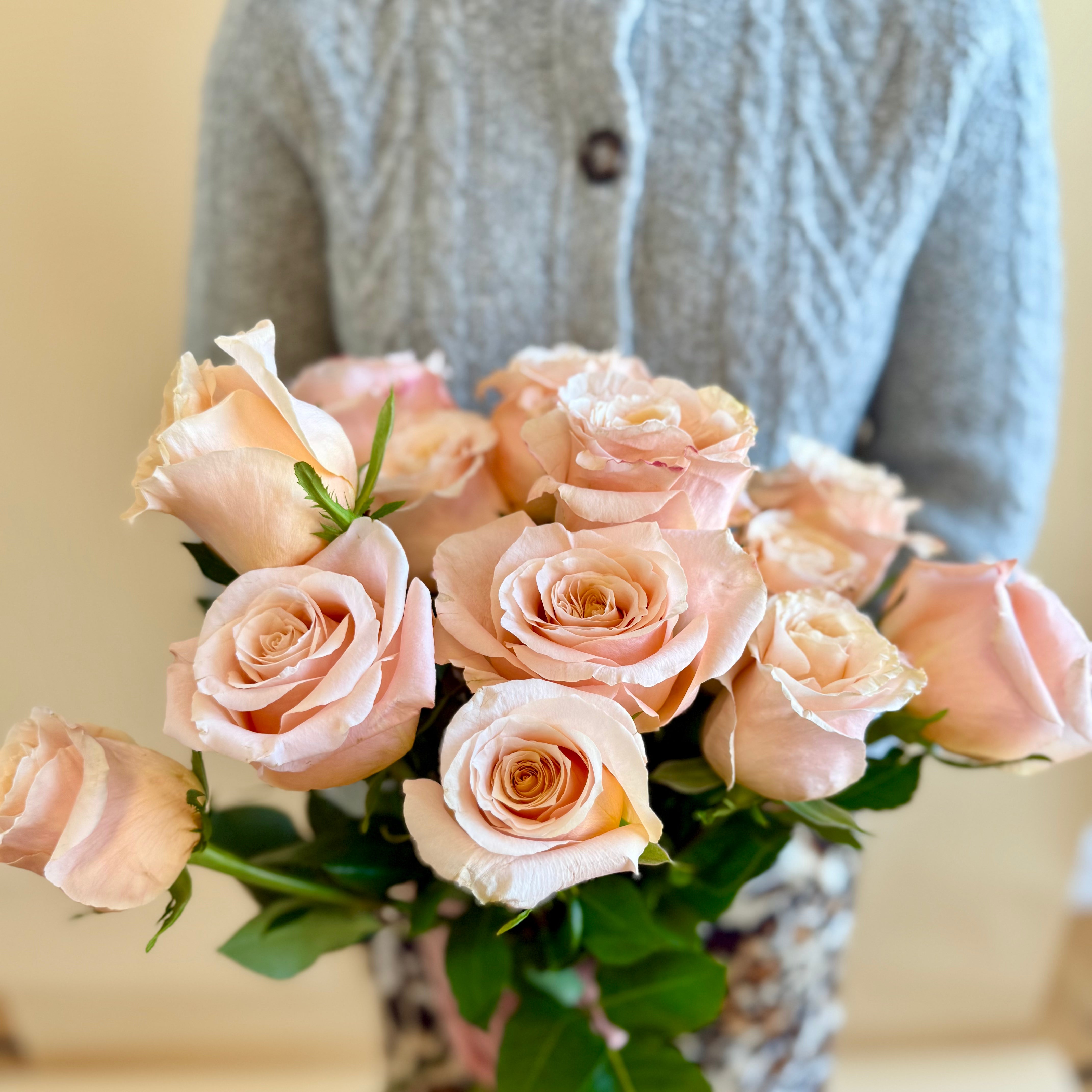 Product shoot of a dozen peach roses.
