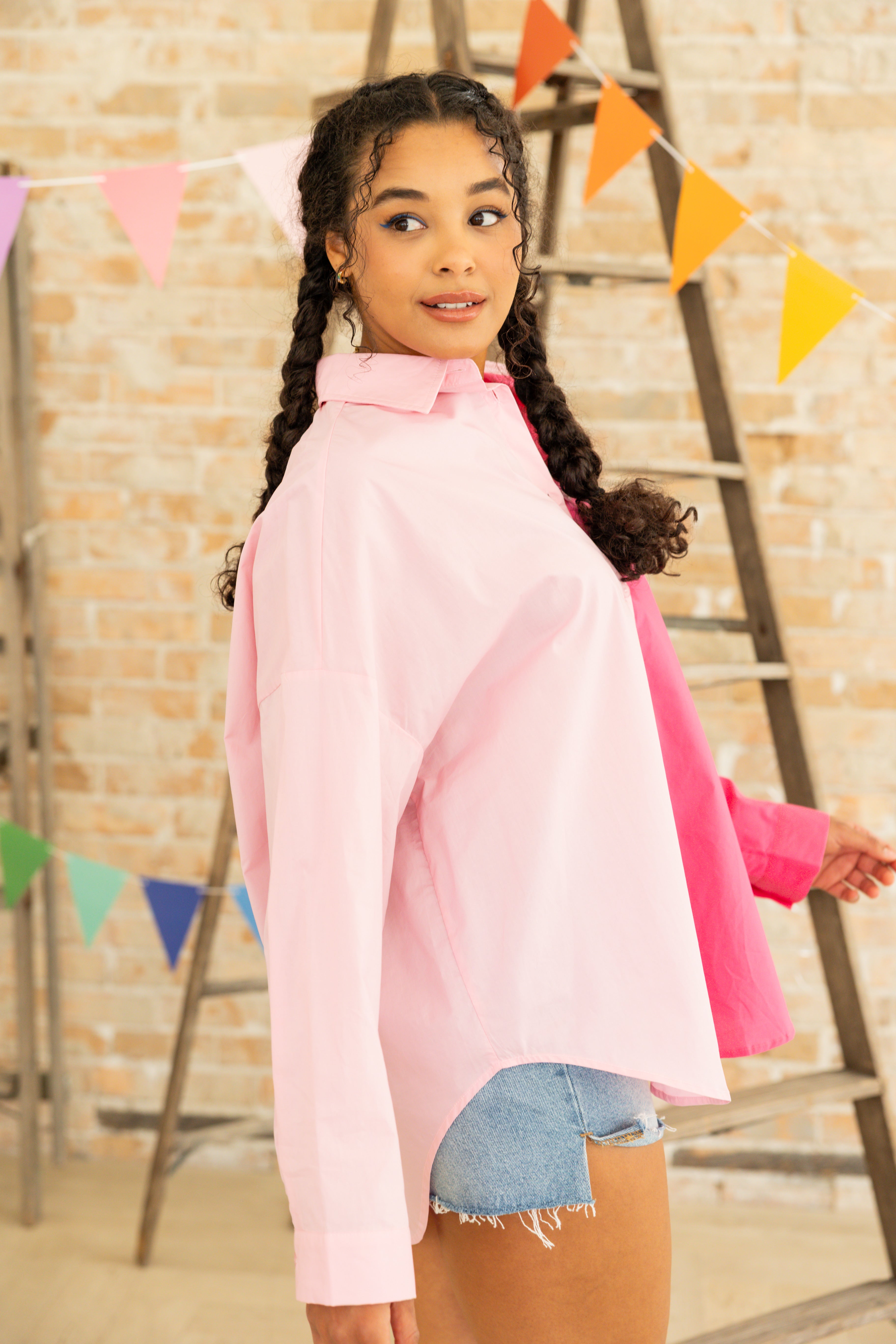 Model is wearing oversized color blocking button up dress shirt.