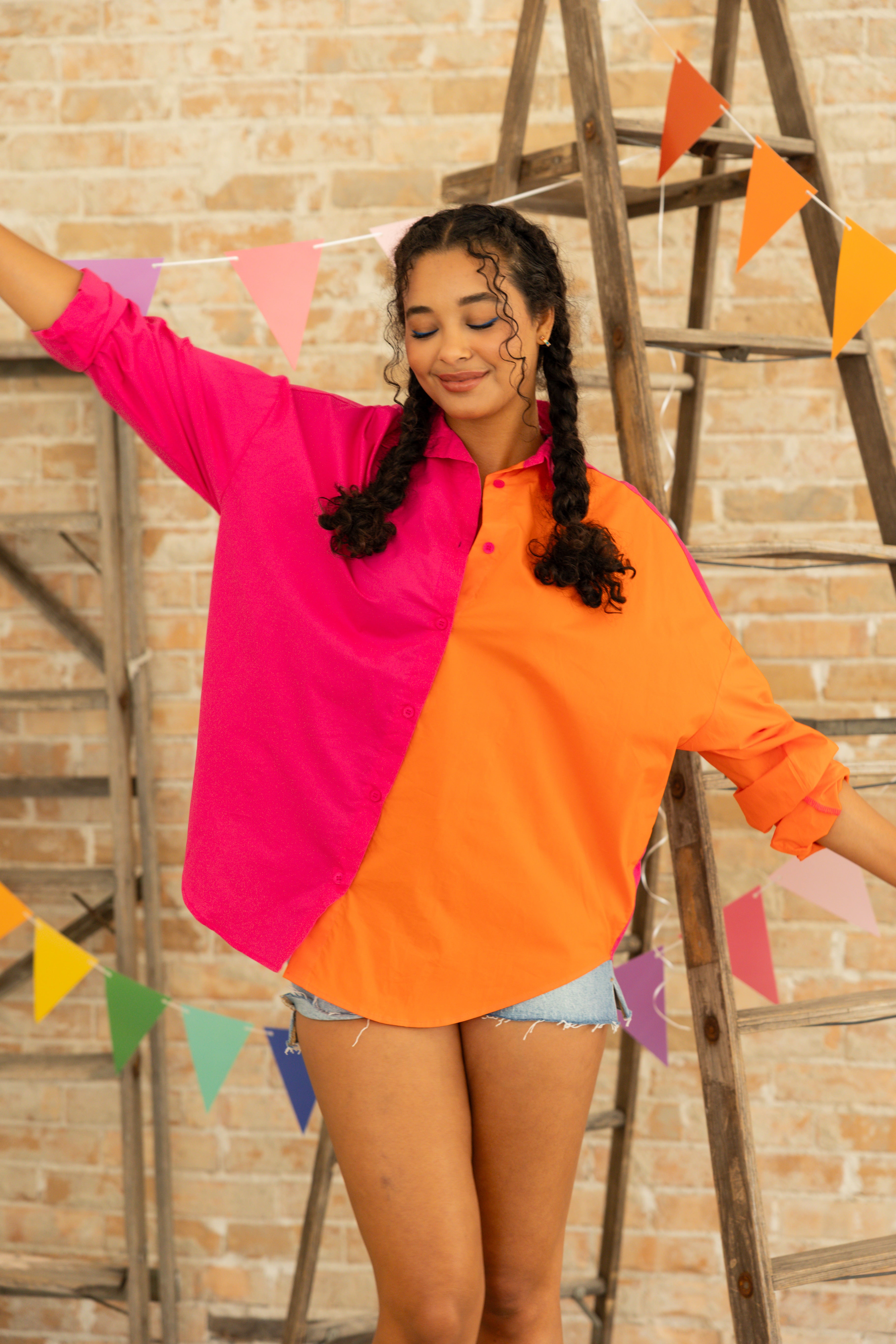Model is wearing oversized color blocking button up dress shirt.