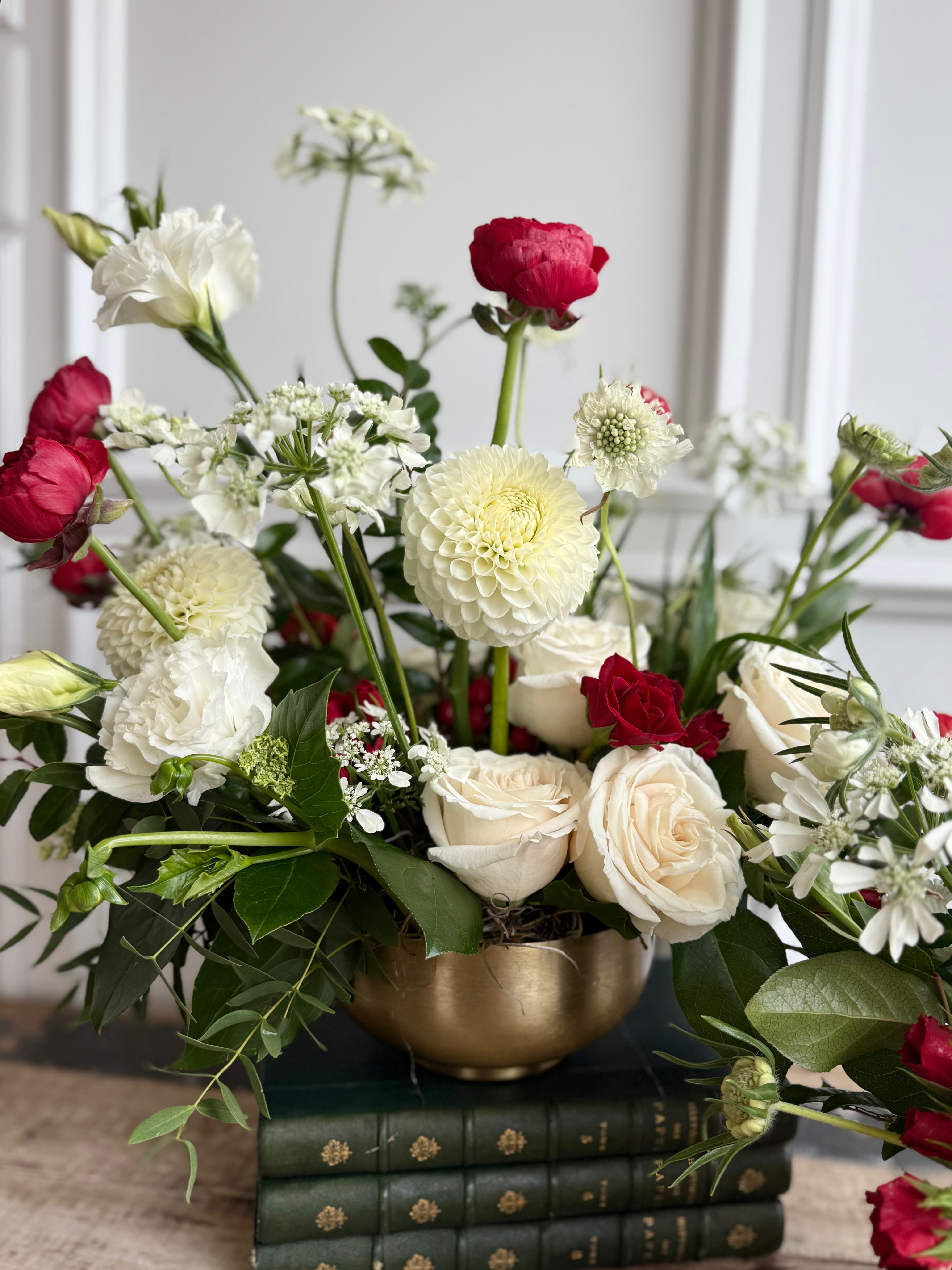 Bouquet features red accents against crisp white blooms and lush greenery.