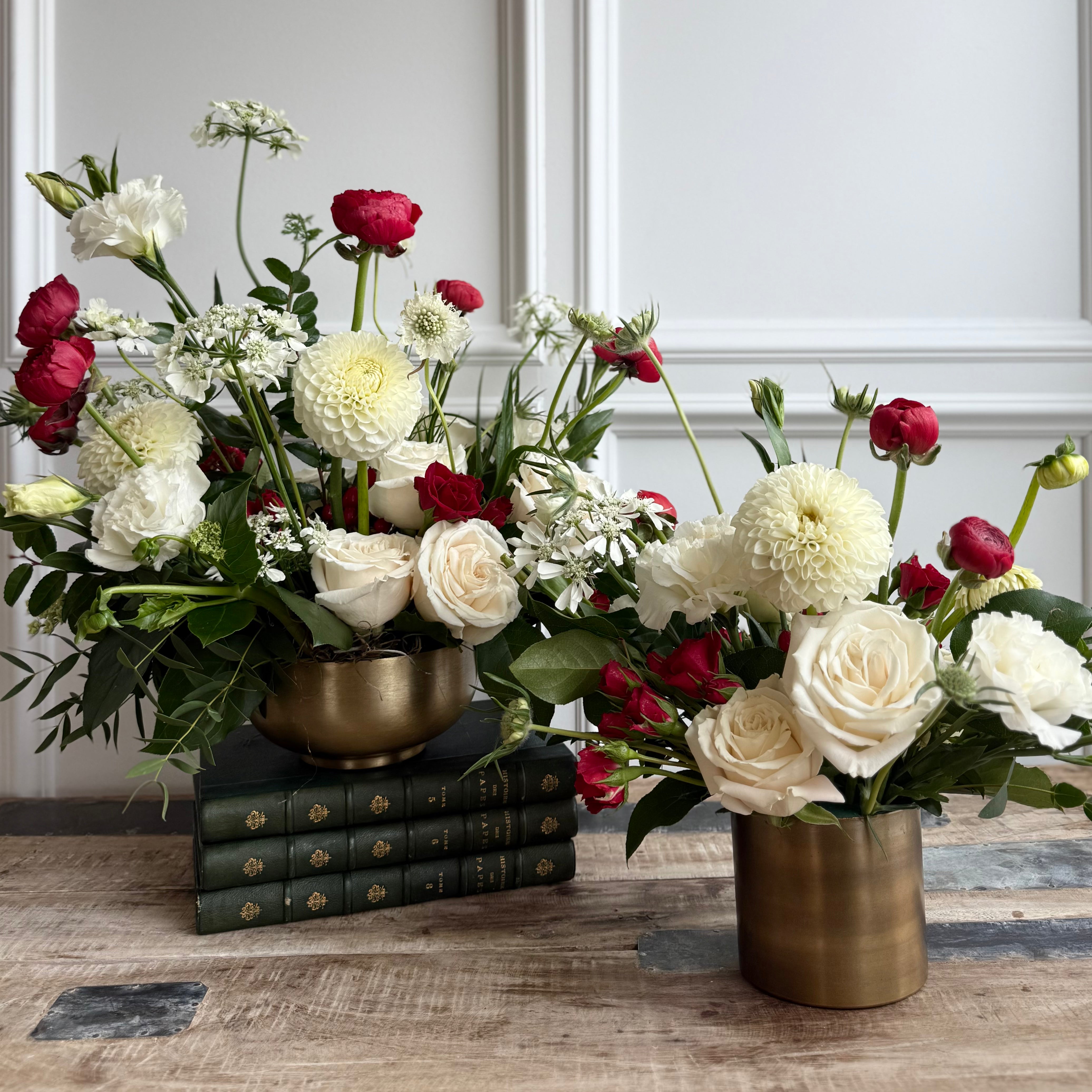Bouquet features red accents against crisp white blooms and lush greenery.