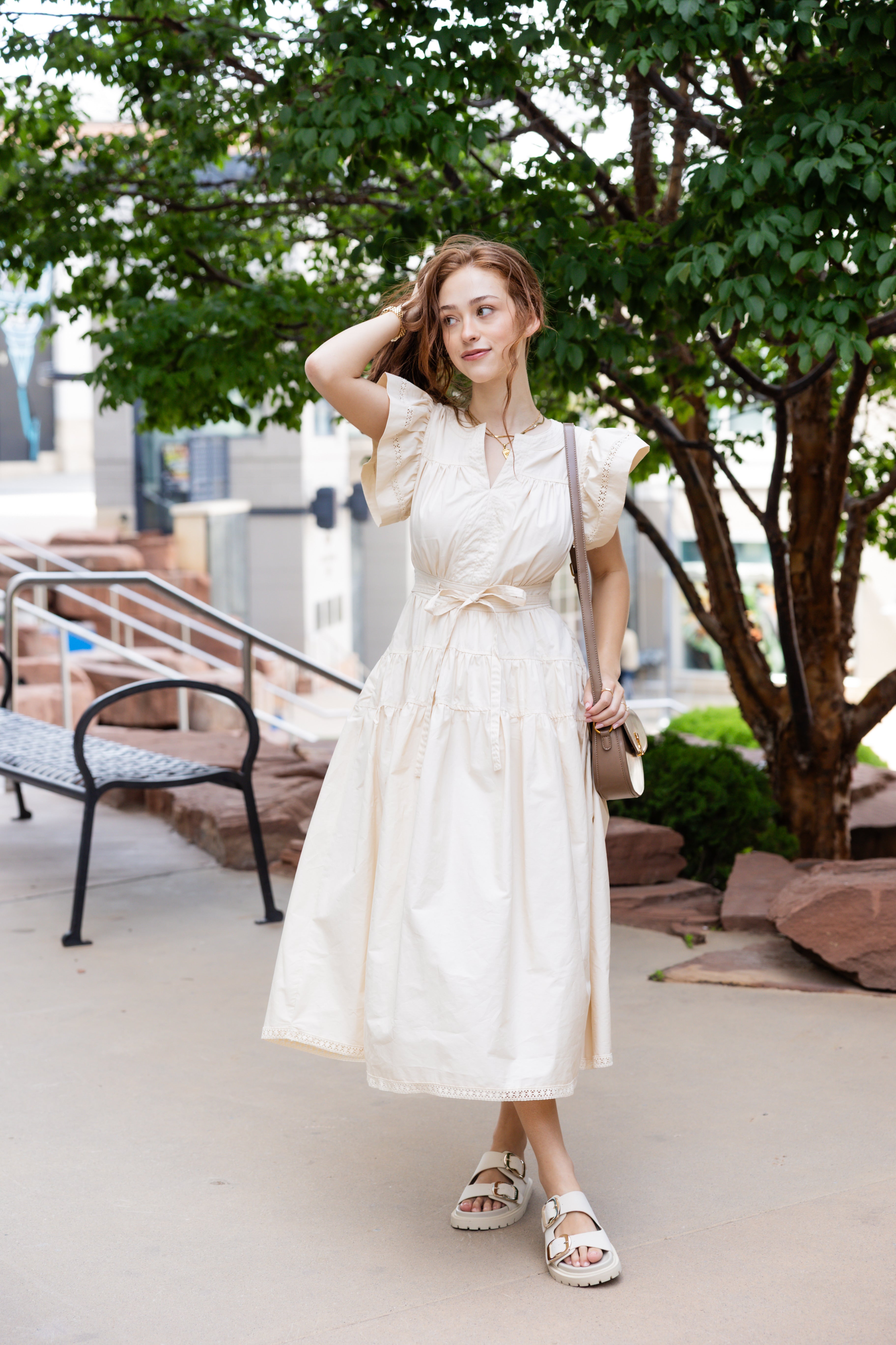 Flutter sleeves, a tiered skirt, and a cinched tie waist midi dress.