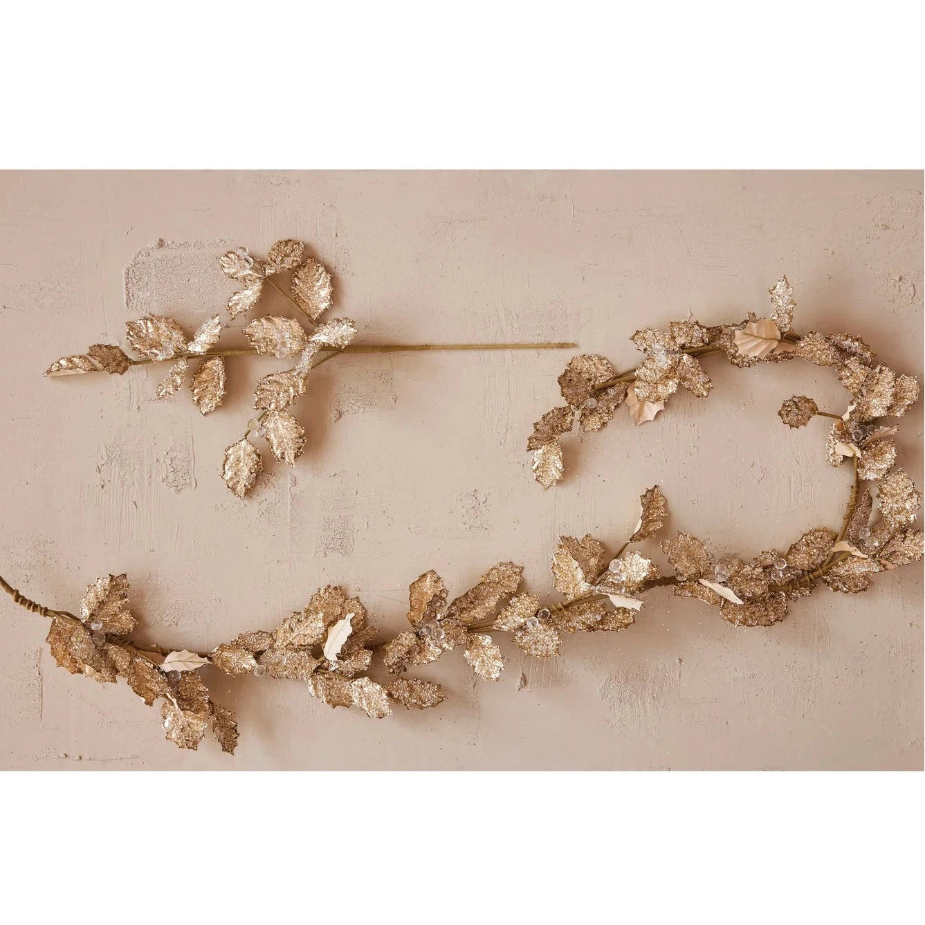 Decorative gold floral hair pins on a beige background