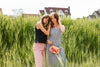 two women standing in long grass on a harbor wearing nautical inspired outfits