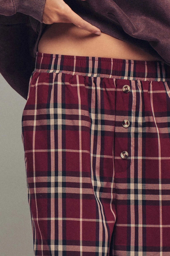 Plaid pants worn by a person on a plain background