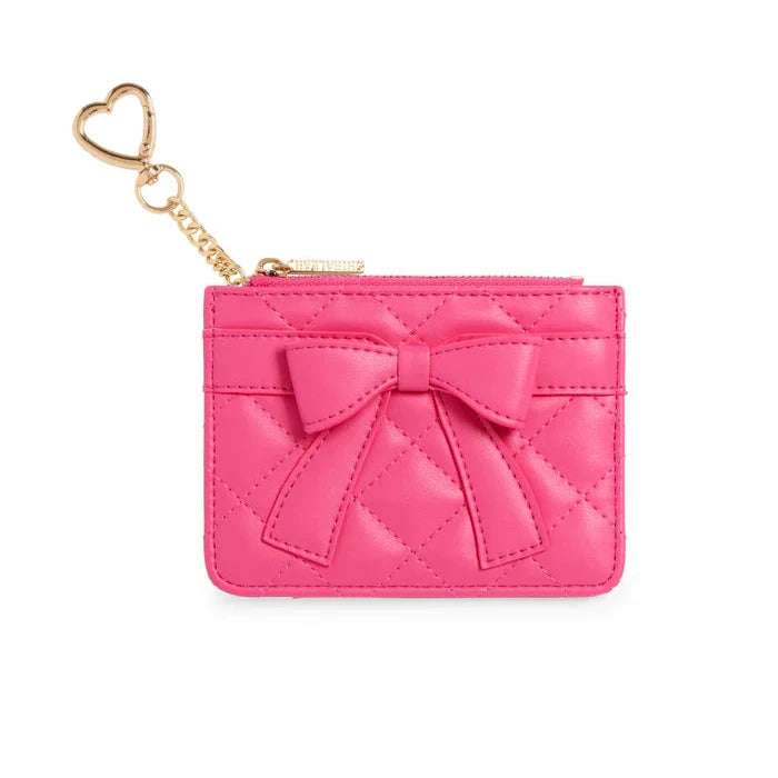 Pink cardholder with bow and gold heart-shaped keychain on a white background