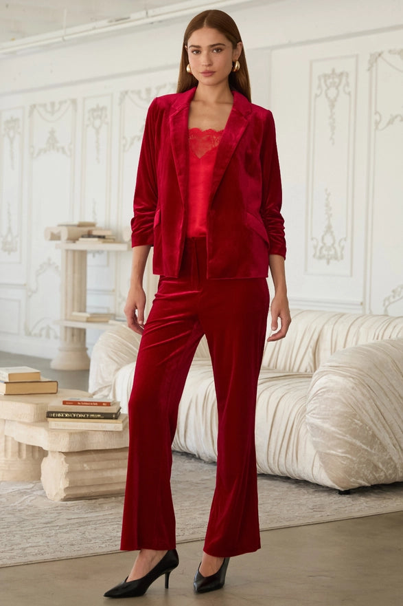 Woman wearing a red outfit in a stylish room with white walls and furniture.