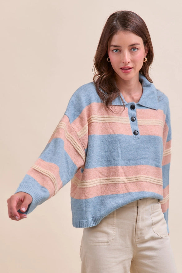 Woman wearing a colorful striped sweater against a beige background