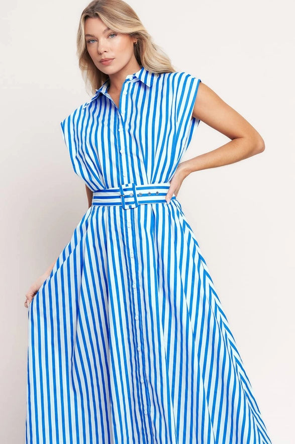 Woman wearing a blue and white striped dress on a plain background