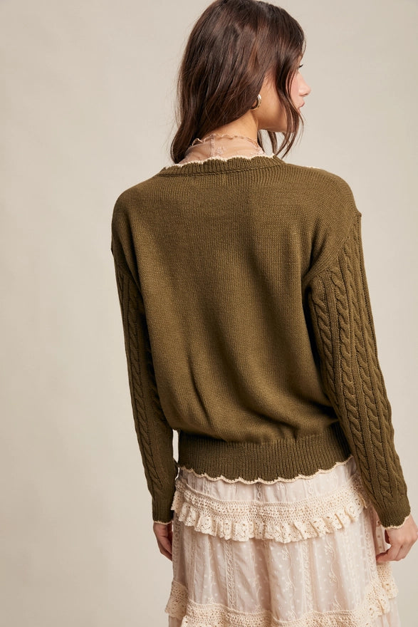 Woman wearing a brown sweater with a beige background