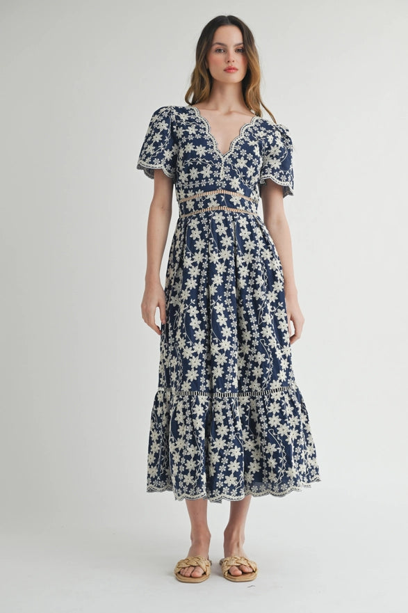 Woman wearing a blue floral dress on a white background