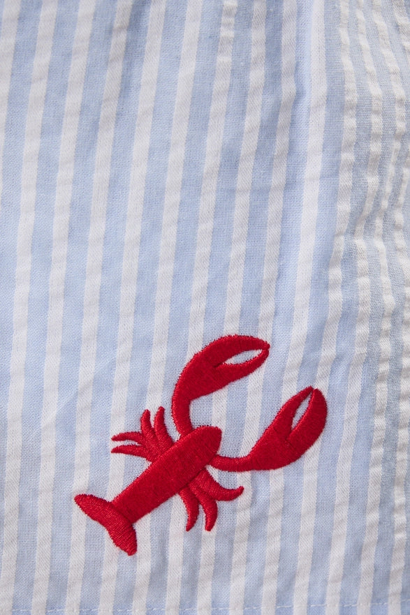 Red lobster design on a blue and white striped fabric