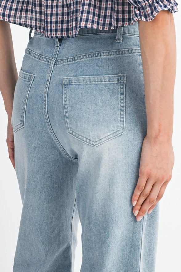Light blue jeans worn by a person on a white background