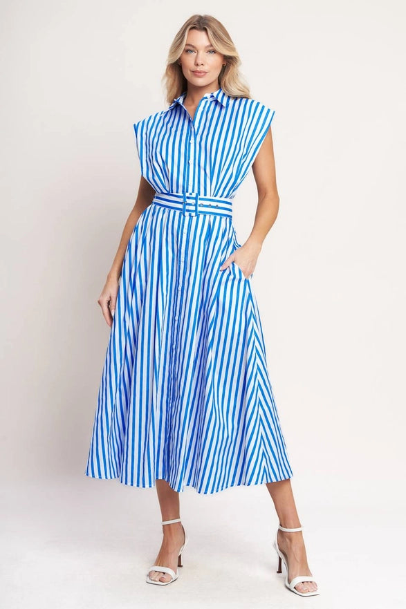 Woman wearing a blue and white striped dress on a plain background