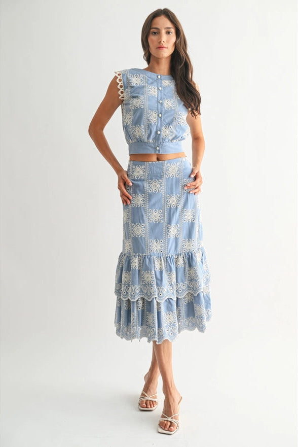 Woman wearing a blue floral dress with a white background