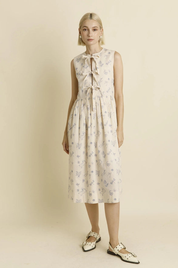 Woman wearing a floral dress on a beige background