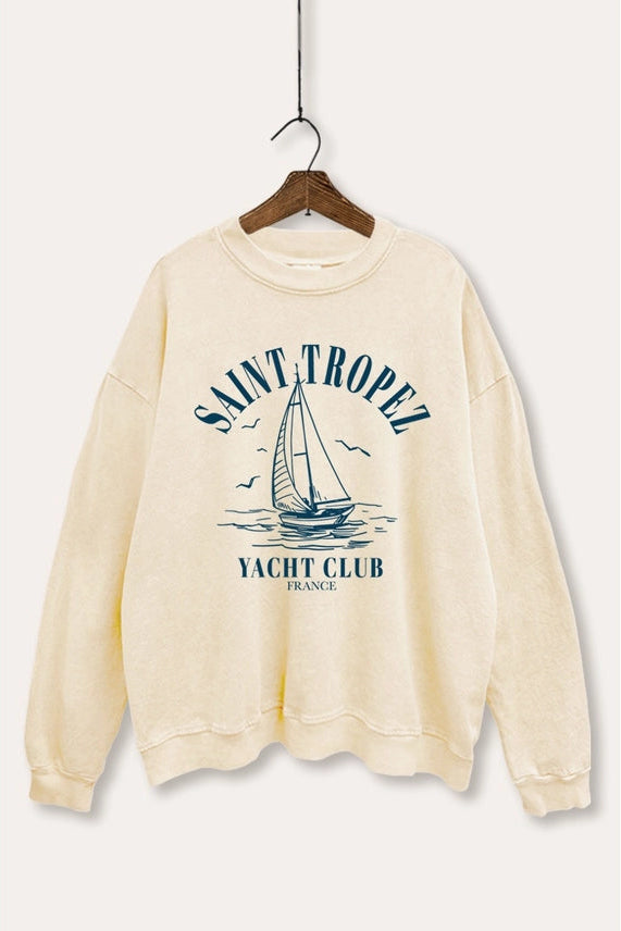 Beige sweatshirt with 'Saint Tropez Yacht Club' design on a hanger against a white background
