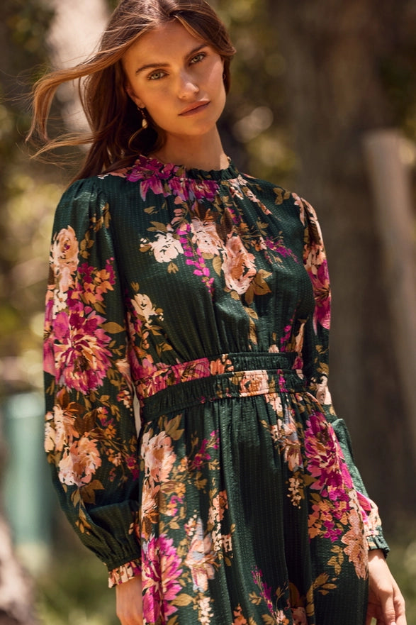 Woman wearing a floral dress with a blurred natural background
