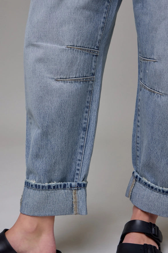 Close-up of blue jeans with a plain background
