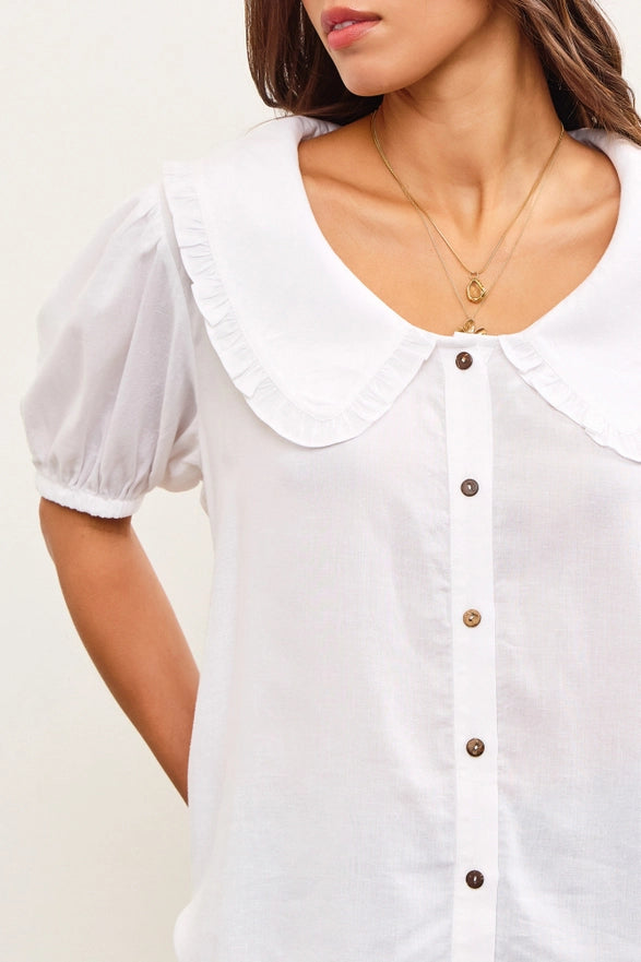 White blouse with a collar and buttons on a plain background
