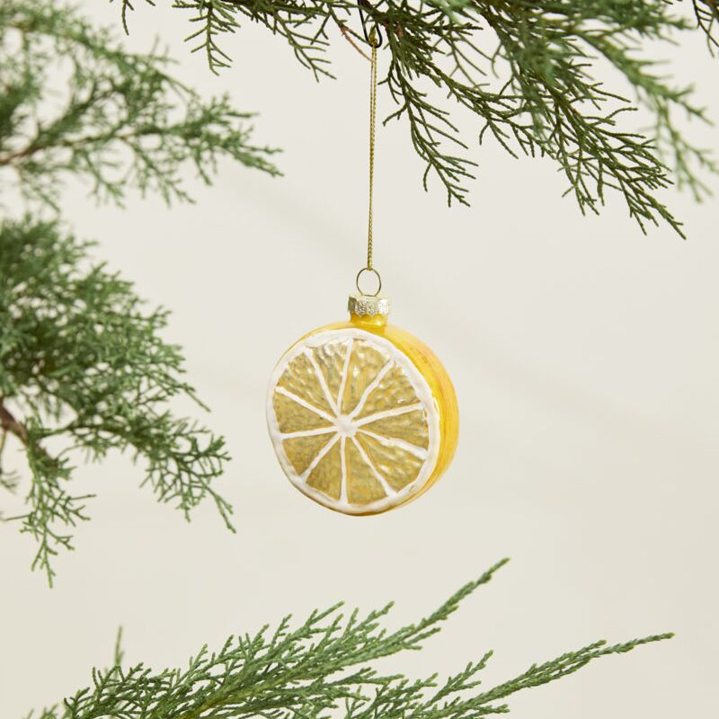 Decorative lemon ornament hanging from a tree branch