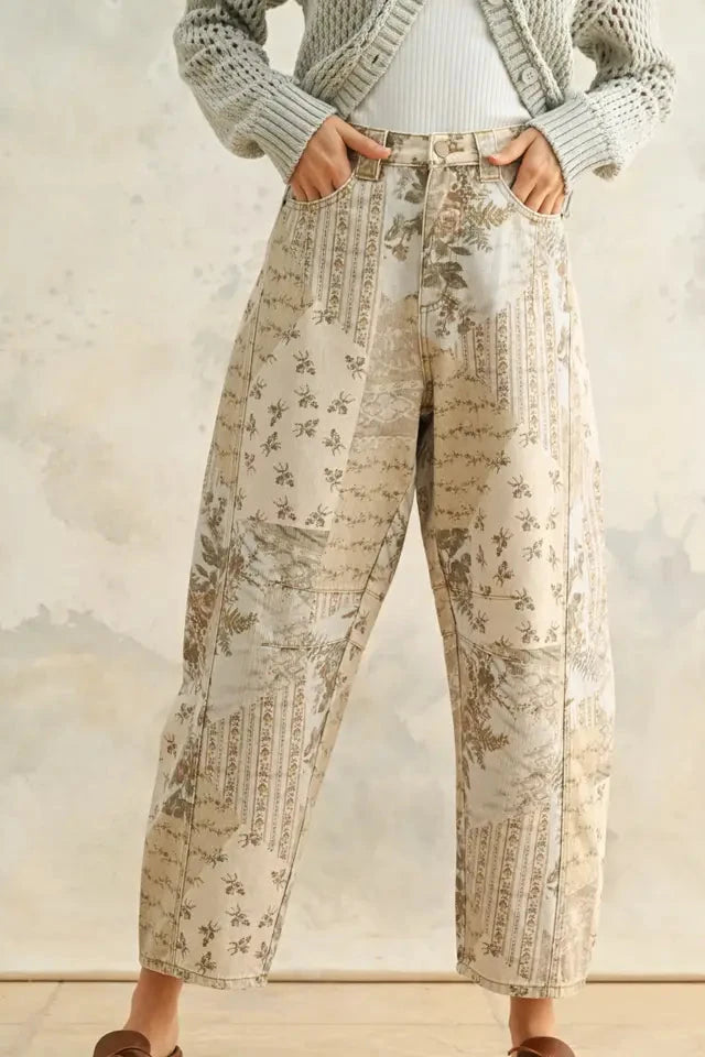 Person wearing floral-patterned pants with a neutral background