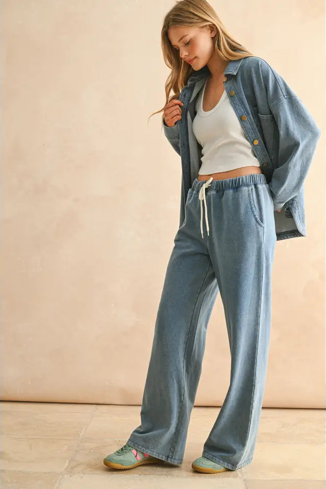Woman wearing a denim outfit with a beige background