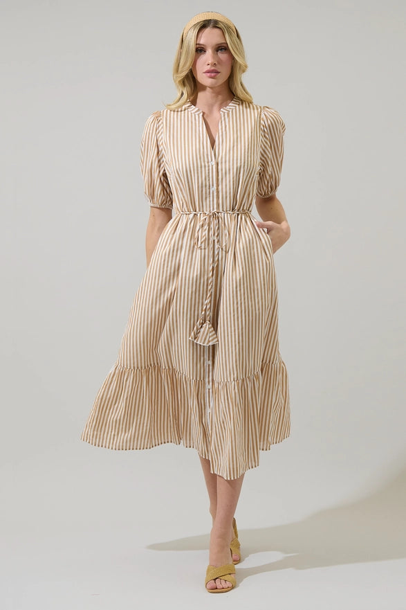 Woman wearing a beige striped dress on a plain background